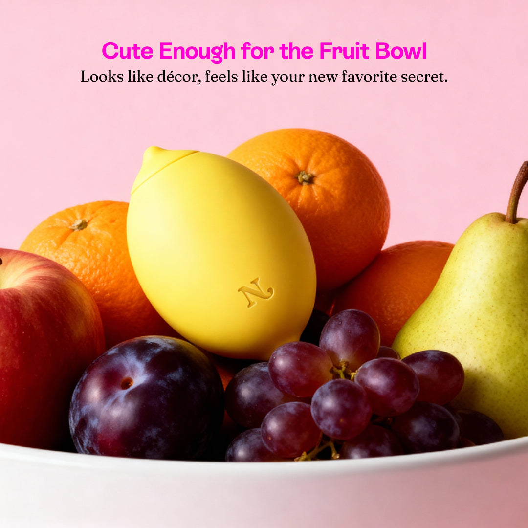 Lem hidden in a fruit bowl with oranges, plums, grapes and a pear
